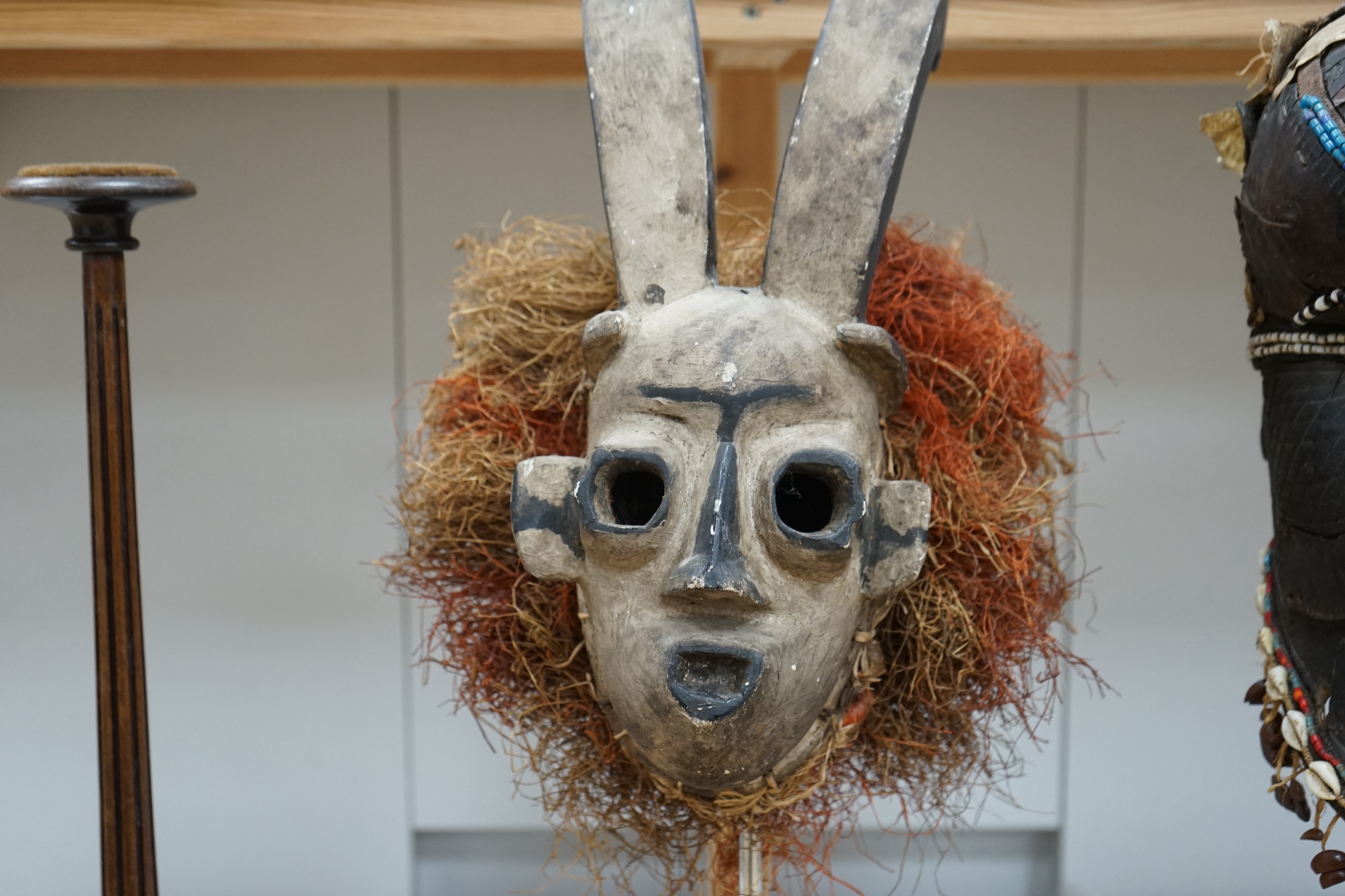 An African Kuba helmet mask and another horned mask, both on stands & one spare. Condition - helmet mask damaged